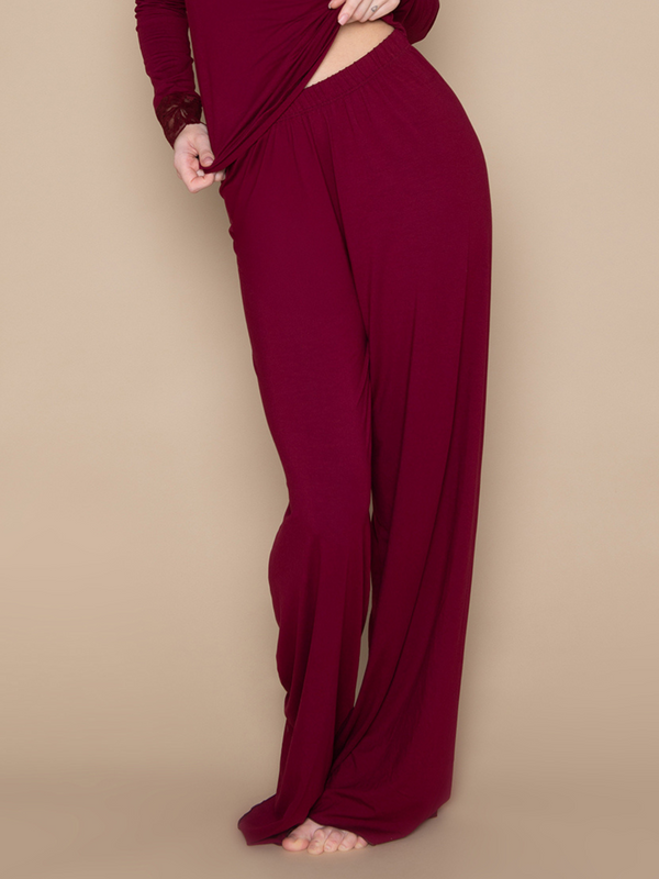 Brunette woman wearing burgundy red soft long lounge pants