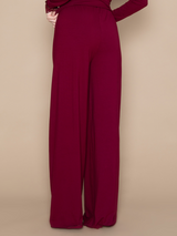 Brunette woman wearing burgundy red soft long lounge pants