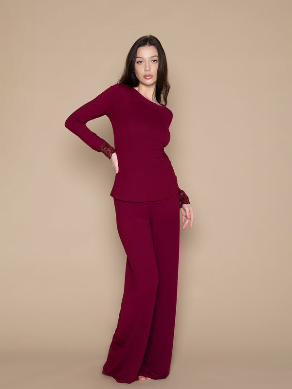 Brunette woman wearing burgundy red soft long lounge pants