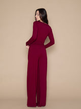 Brunette woman wearing burgundy red soft long lounge pants and long sleeved top